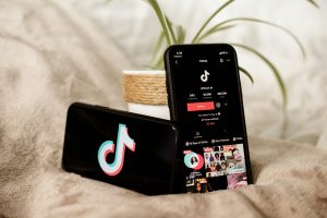 tick tok app open on a horizontal and vertical staged iphones - micro influencers, influencer marketing 2025, community engagement, niche influencers, brand partnerships